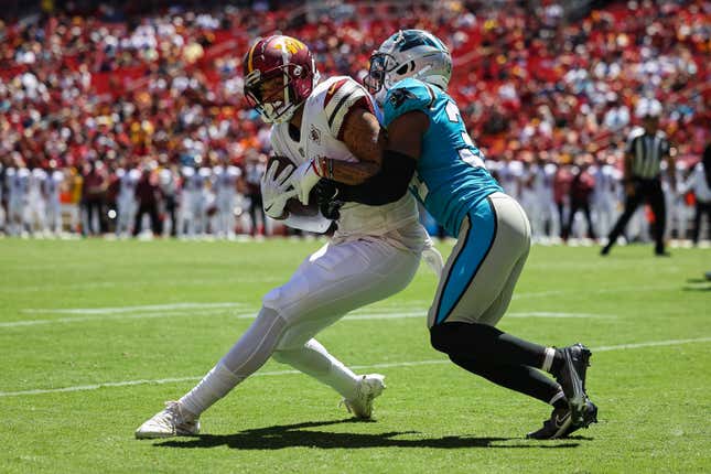 Curtis Hodges of the Washington Commanders catches a pass as Sean Chandler of the Carolina Panthers defends during the first half of the preseason game in 2022.