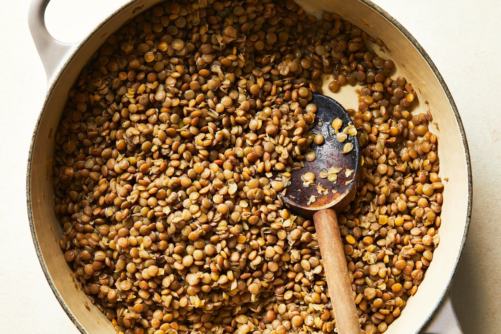 An overhead image of lentils in a Dutch oven.